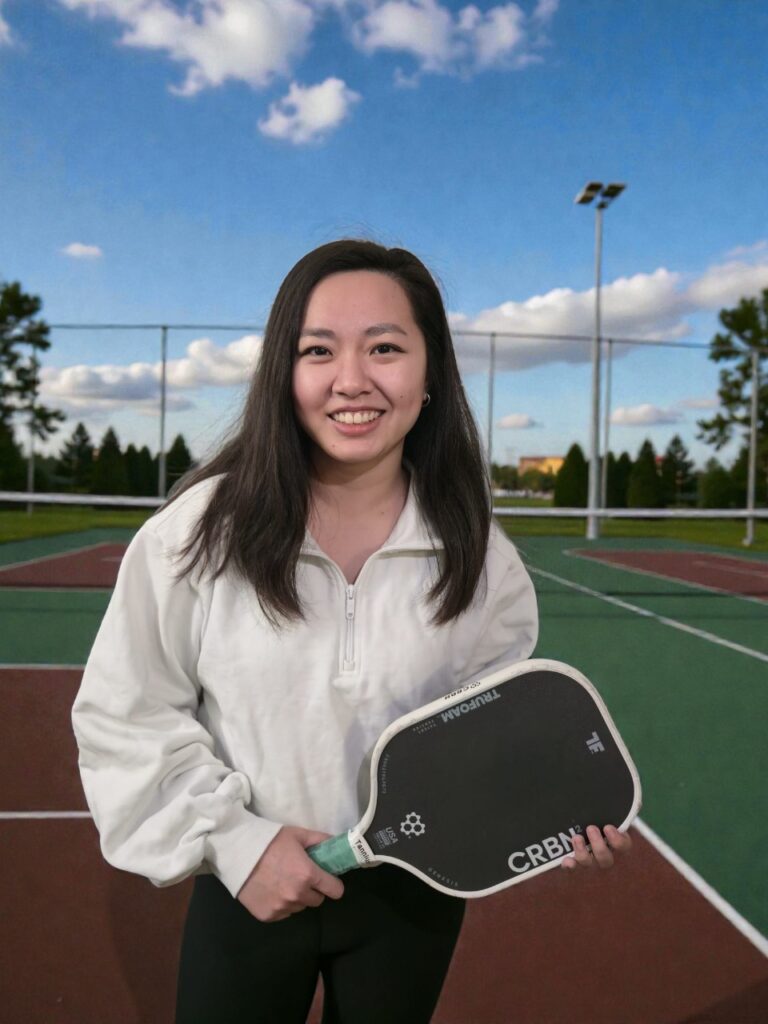 Player holding a paddle on an outdoor pickleball court
